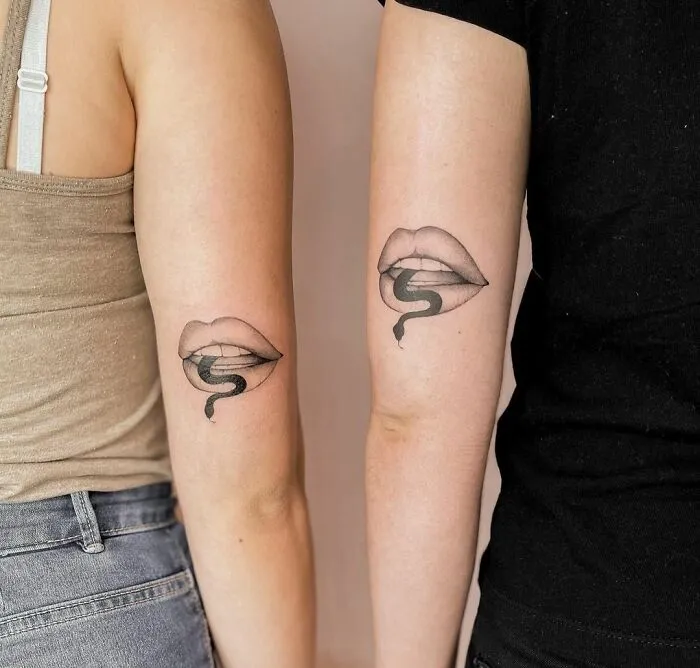 Matching snake and lips tattoos on two people's arms symbolizing best friend tattoos.