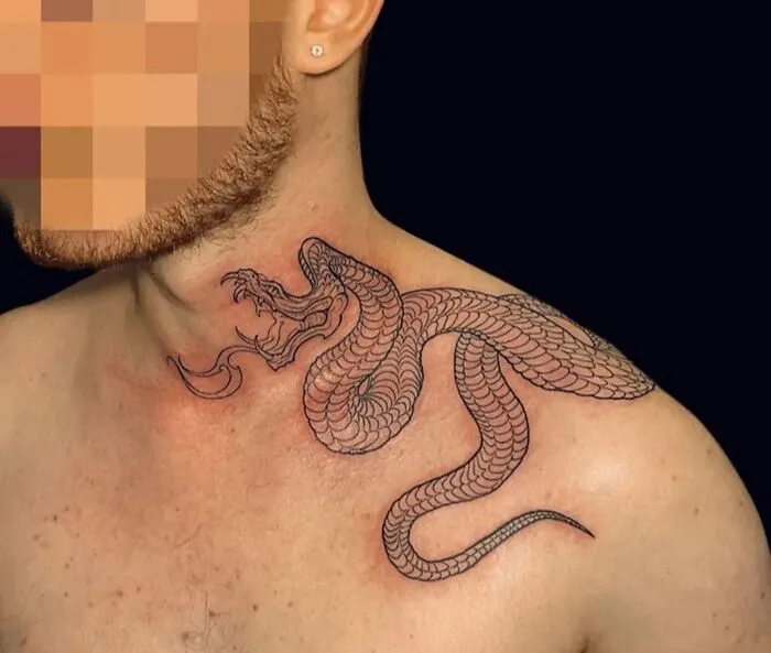 Chest tattoo of a detailed snake design, celebrating the animal kingdom.