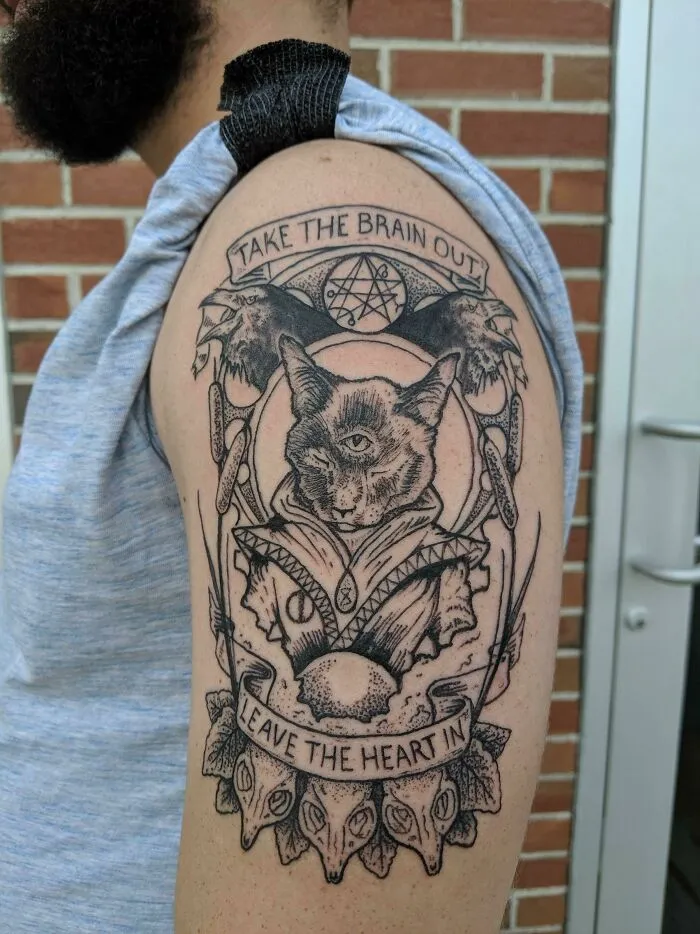 Arm tattoo featuring a detailed cat design, symbolizing the unique bond between humans and pets.
