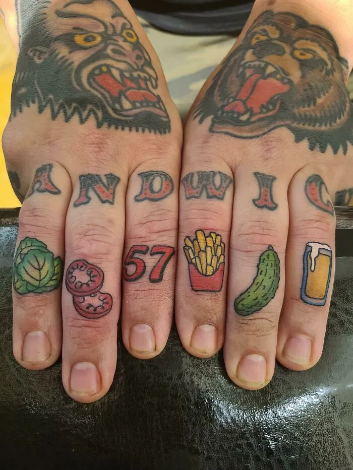 Creative word tattoos on fingers with food icons and animal motifs.