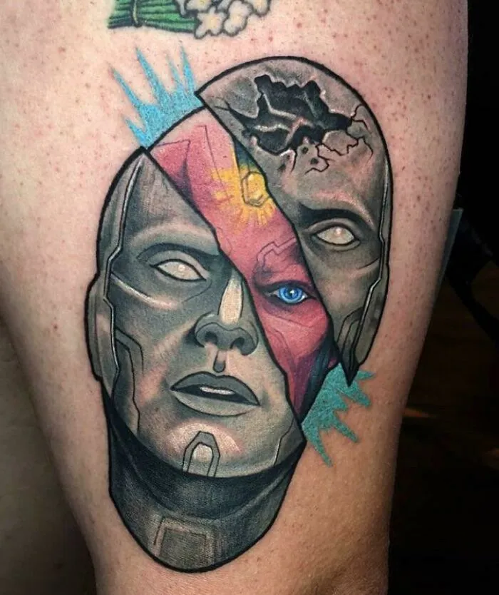 Marvel tattoo of a robotic face with fractured mask design on skin.