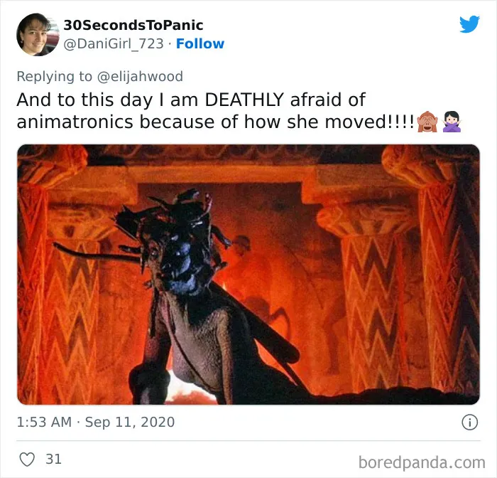 Scary single shot from a film showing a creepy animatronic figure in a dark, fiery ancient temple setting.