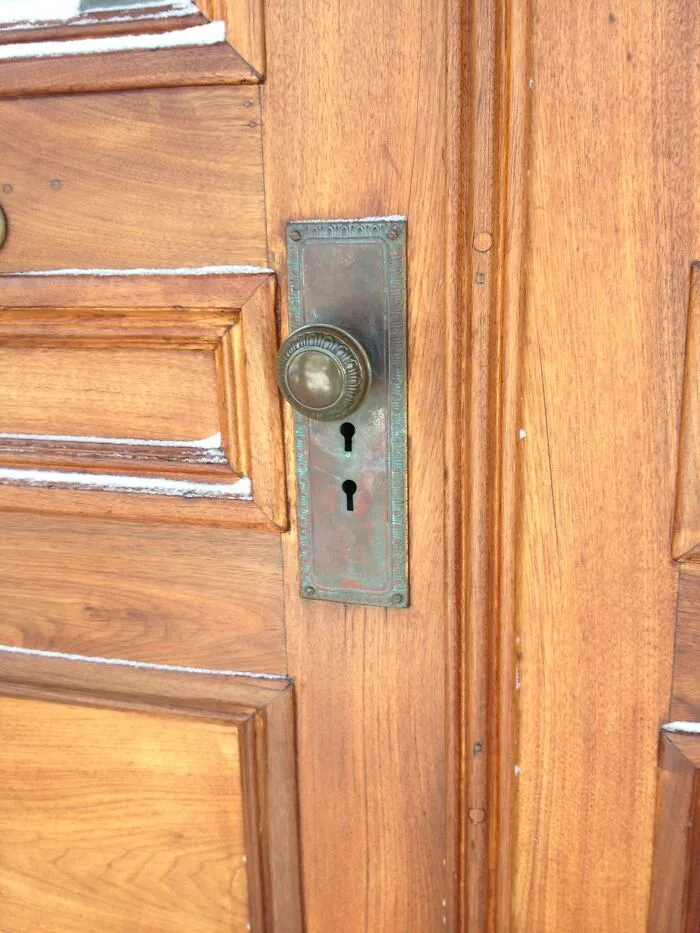 Wooden door with an antique doorknob and keyhole, creating an unlikely, chucklesome visual story.