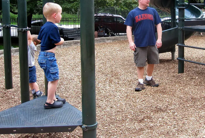 A Man Playing With A Child At A Playground