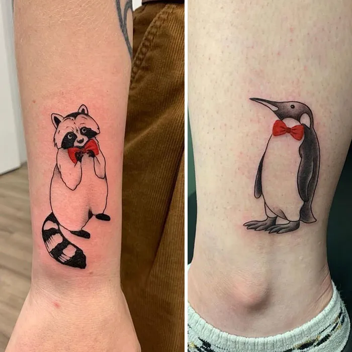 Raccoon and penguin tattoos with red bow ties symbolizing friendship.