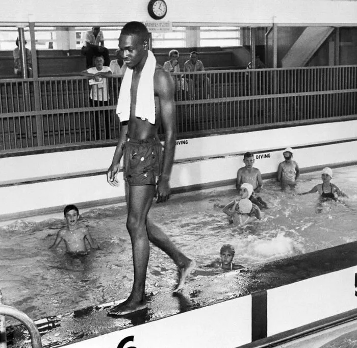 Swimming pool with multiple people swimming in it 