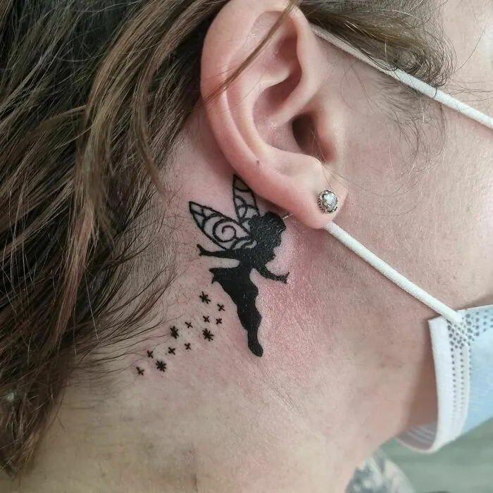 Fairy ear tattoo in black ink on person's skin, showcasing creative ear tattoo ideas.