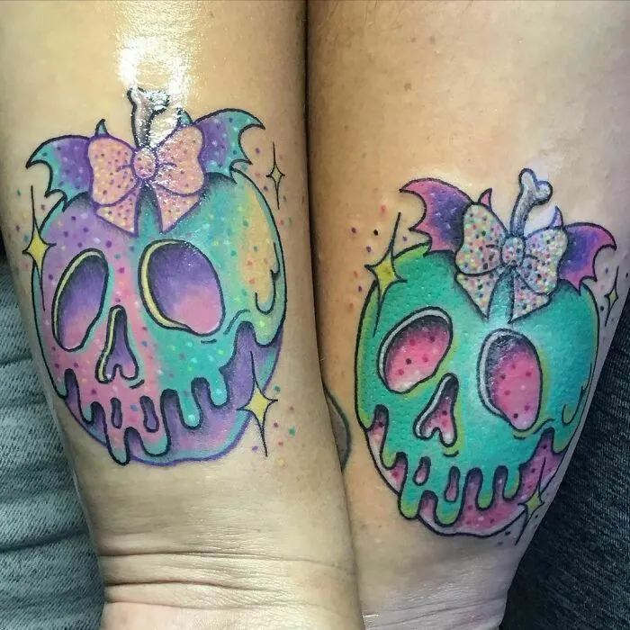 Colorful skull best friend tattoos with bows and bat wings.
