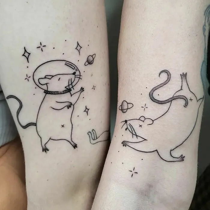 Rat-themed best friend tattoos on forearms, celebrating friendship with matching cosmic designs.