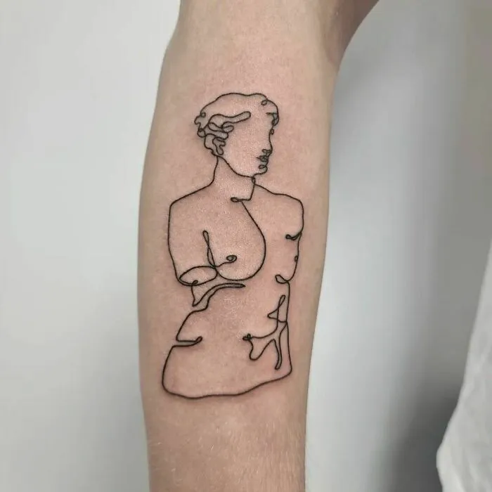 Fine-line perfection with a single-line tattoo of a classical bust on an arm.