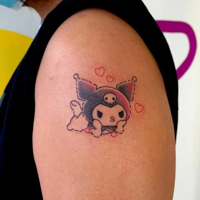 Cartoon tattoo of a cute character with hearts on an arm, inspired by popular animated shows.