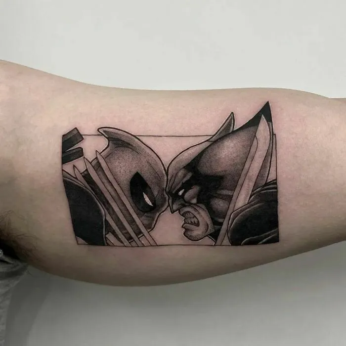 Marvel tattoo of two masked characters Deadpool And Wolverine facing each other on an arm.