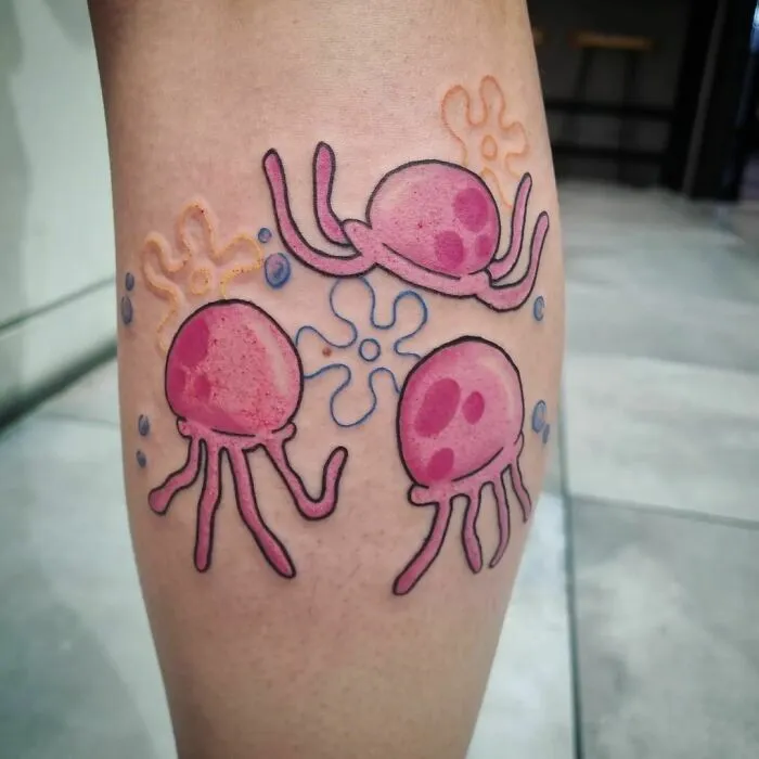 Cartoon tattoo featuring pink jellyfish inspired by popular animated shows.
