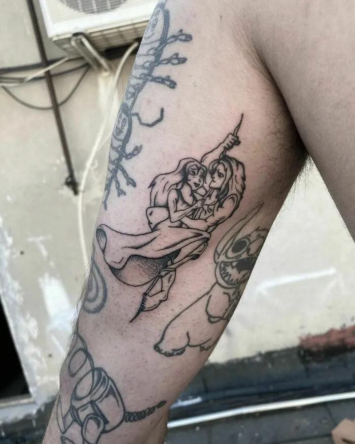 Cartoon tattoo depicting characters from a beloved animated show on an arm.