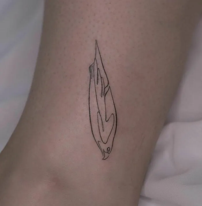 Fine-line single-line tattoo of a stylized feather on skin.