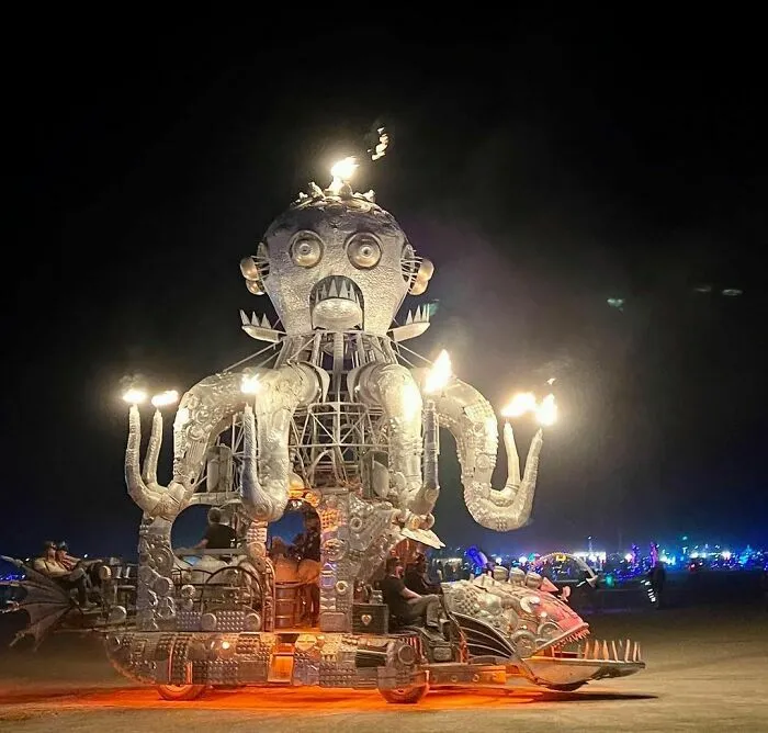 Metallic statue of Octopus standing on fish throwing fire 