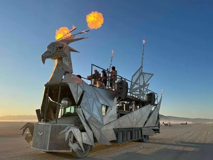 Car shaped as Phoenix with people in it 