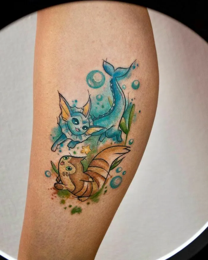 Watercolor tattoo of cartoon aquatic creatures with vibrant colors on a person's calf.