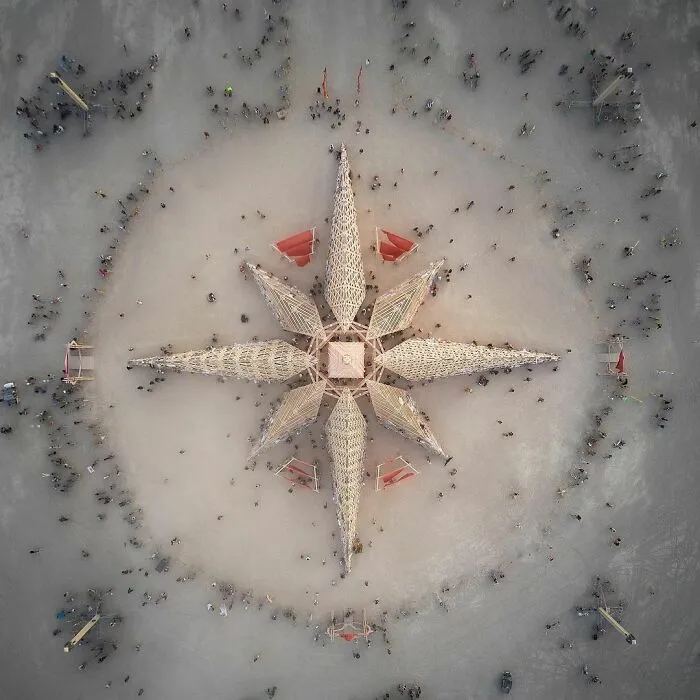 Aerial view of star installation with a lot of people around it 