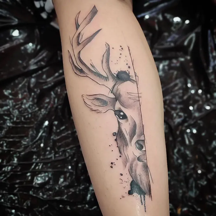 Deer tattoo on forearm, showcasing realistic and simple design elements.