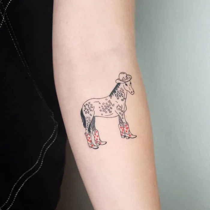 Tattoo of a horse wearing a cowboy hat and boots, celebrating the animal kingdom.