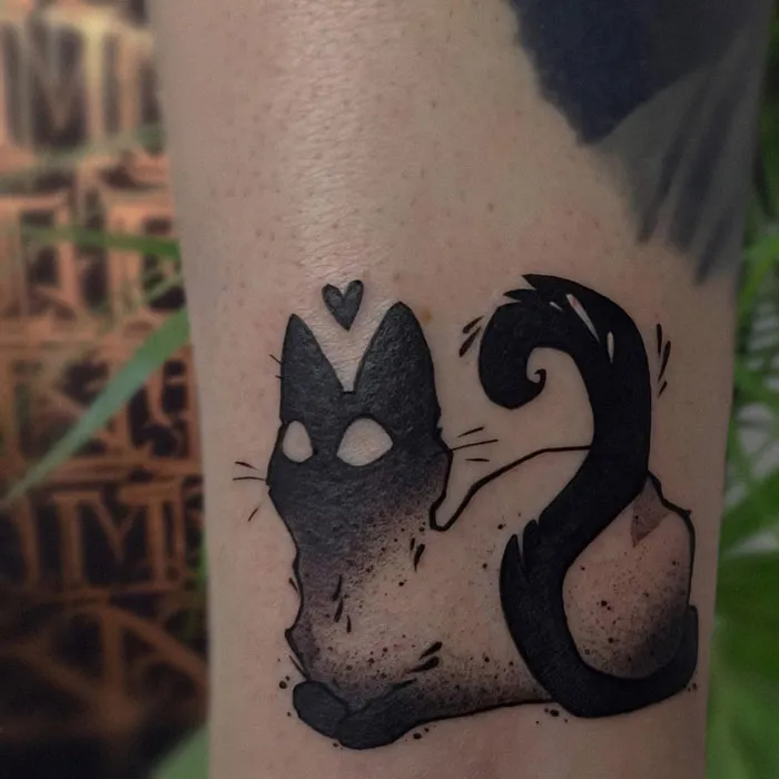 Minimalist animal tattoo of a black cat silhouette with a heart on the head, displaying simplicity and realism.