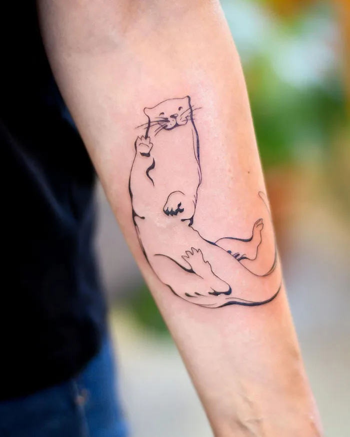 Otter tattoo on forearm celebrating the animal kingdom with minimalist line art.