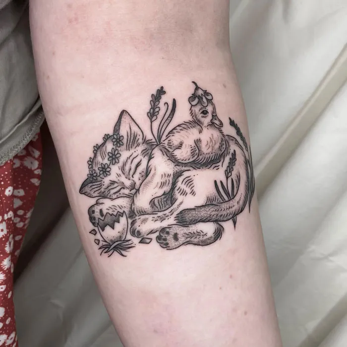 Tattoo of a sleeping fox surrounded by flowers, showcasing simplicity and realism in animal art.