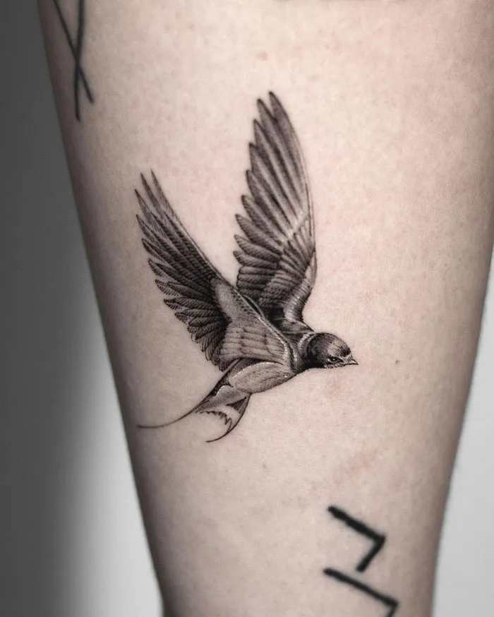 Tattoo of a swallow flying, detailed design celebrating the animal kingdom.