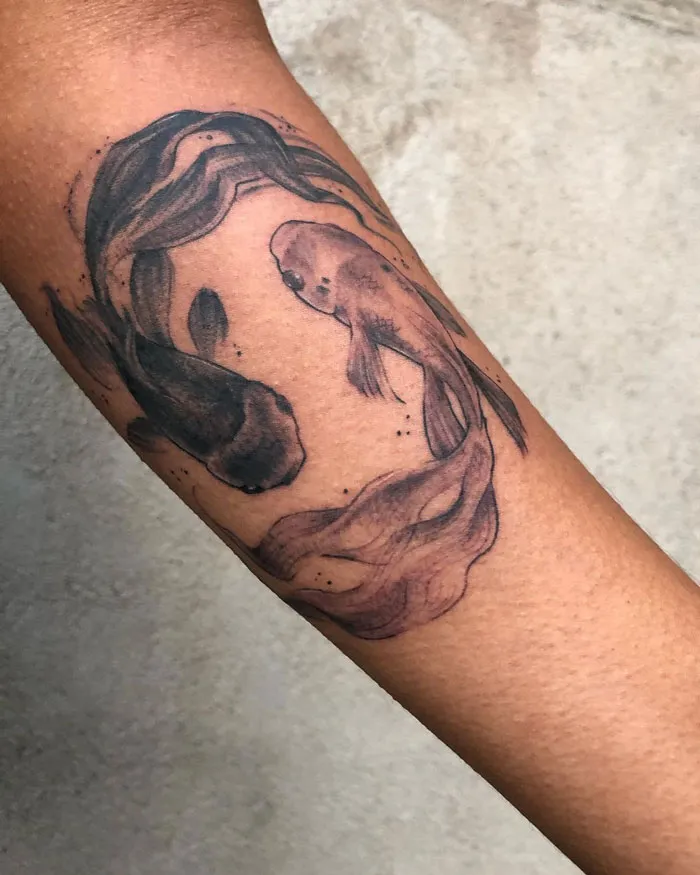 Minimalistic koi fish animal tattoo on forearm, showcasing realism and simplicity.