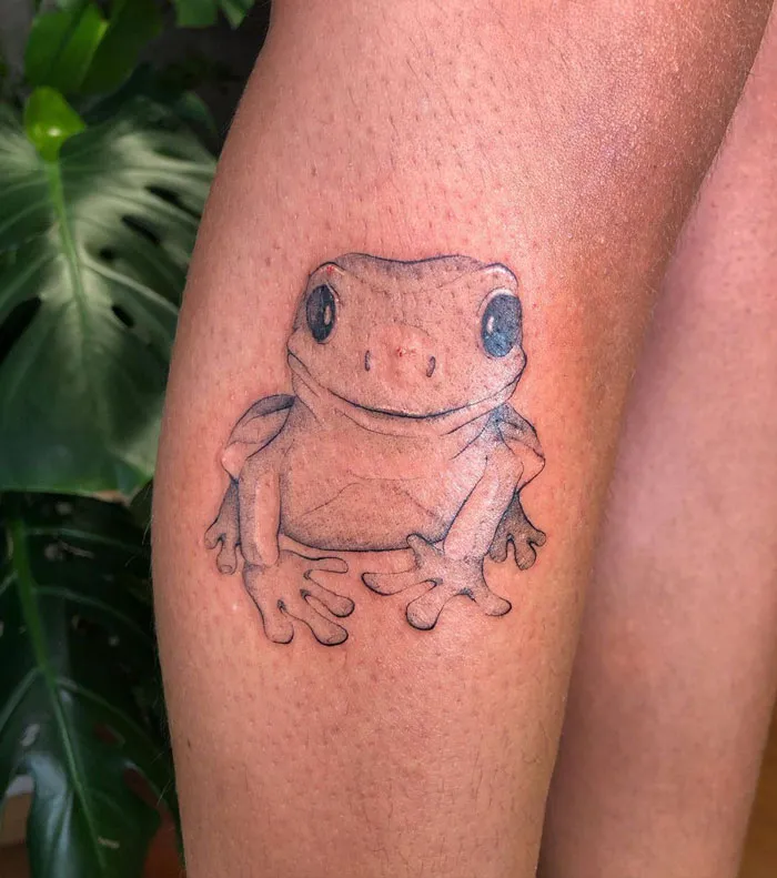 Realistic frog tattoo on a leg, showcasing simplicity and detail in animal design.