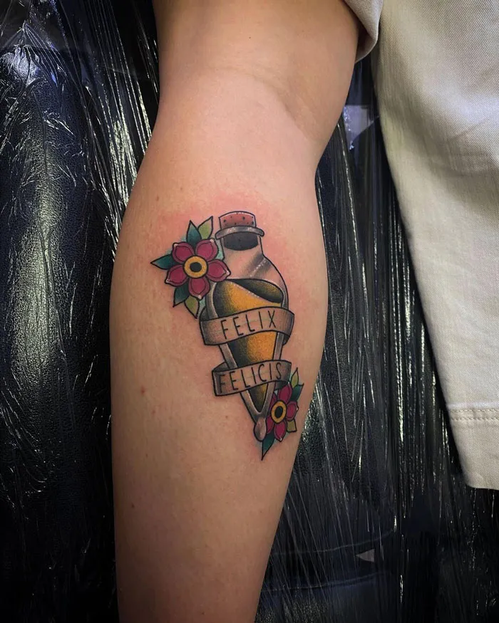 Unique calf tattoo featuring a potion bottle labeled "Felix Felicis" with vibrant flowers on the side.