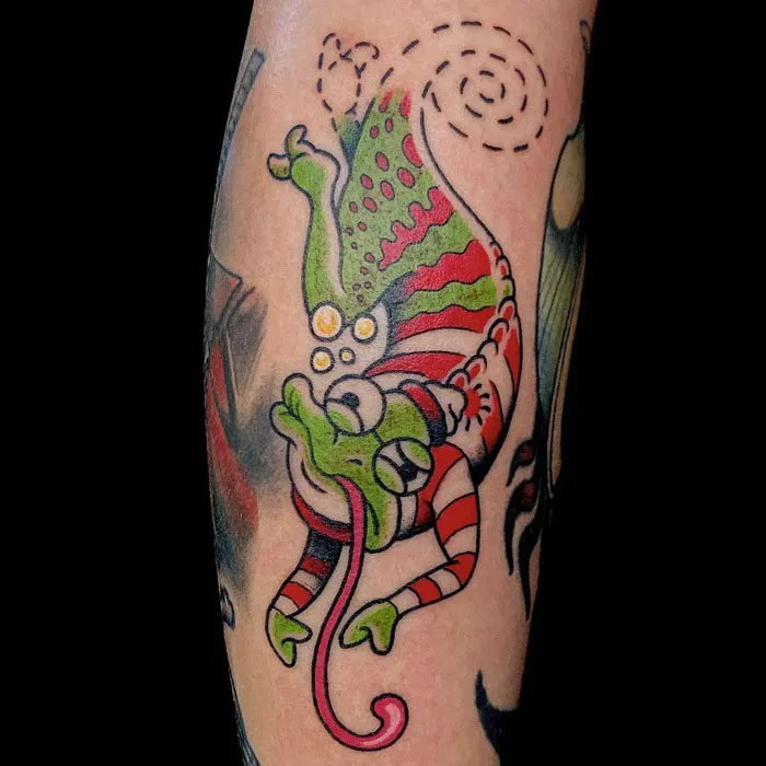 Colorful frog calf tattoo design with unique red and green patterns.