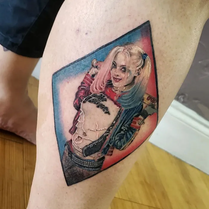 Lower leg tattoo featuring a colorful comic-inspired character in a playful pose.