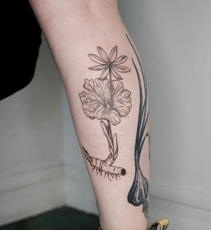Floral calf tattoo with delicate line work and botanical detail.
