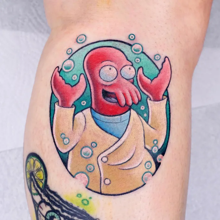 Colorful calf tattoo of a cartoon character surrounded by bubbles, showcasing cool tattoo artistry.