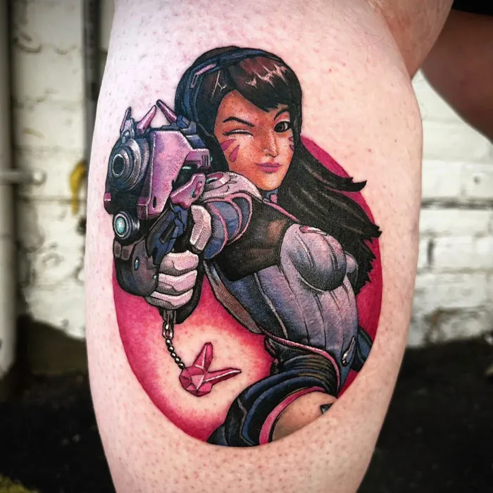 Lower leg tattoo featuring a colorful, detailed illustration of a woman in a futuristic outfit holding a weapon.