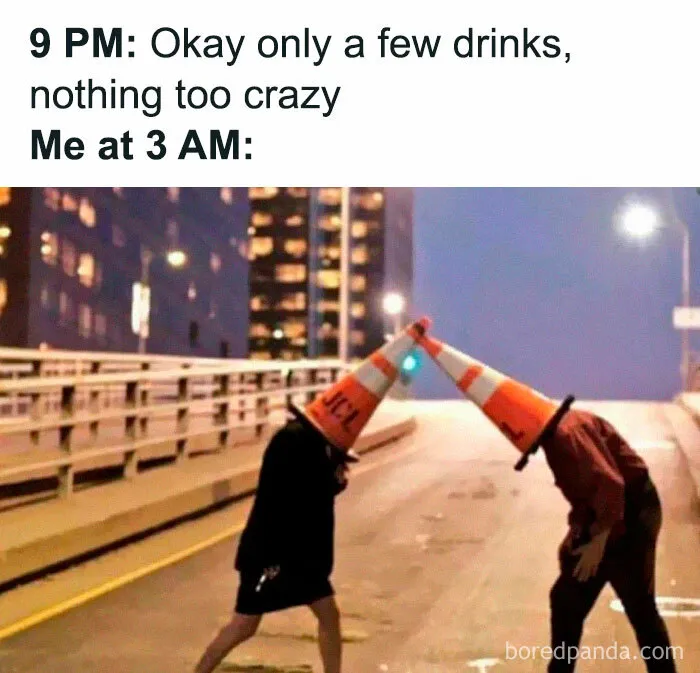Two people on a street at night wearing traffic cones on their heads, symbolizing iconic internet meme culture.