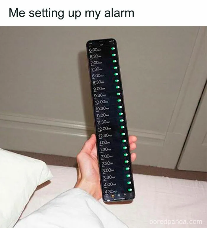 Person holding phone with multiple alarms set, showcasing an iconic meme of internet culture.