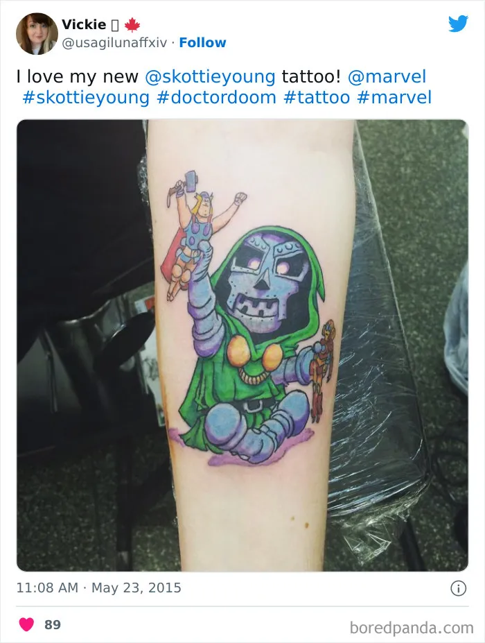 Marvel tattoo of Doctor Doom with Thor doll on forearm, showcasing comic art style and colorful design.