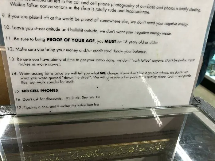 Tattoo shop rules sign detailing etiquette and expectations for difficult customers.