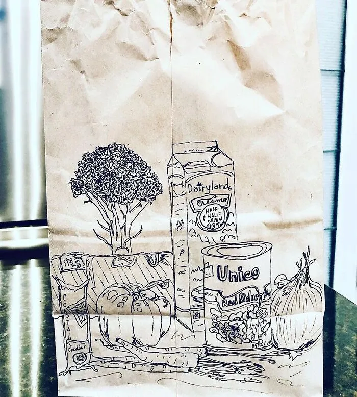 Still life drawing on a paper bag featuring groceries like milk, broccoli, tomatoes, and beans.