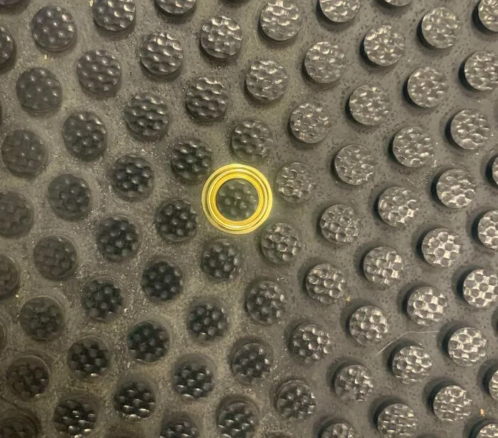 Metal Grommet Fell Onto A Floor Mat At My Work