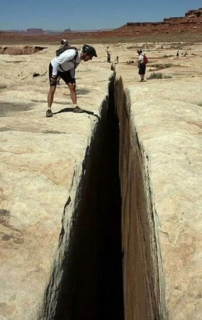 The Black Crack, A 65-Foot-Deep Fissure Along A Trail In Canyonlands National Park In Utah