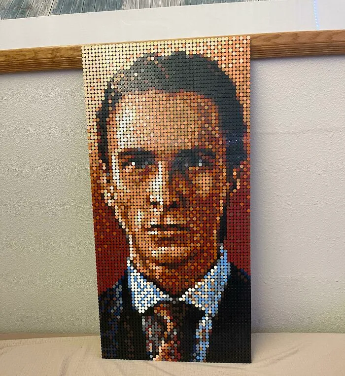 LEGO pixel art portrait of a man in a suit showcasing incredible LEGO builds as detailed works of art.