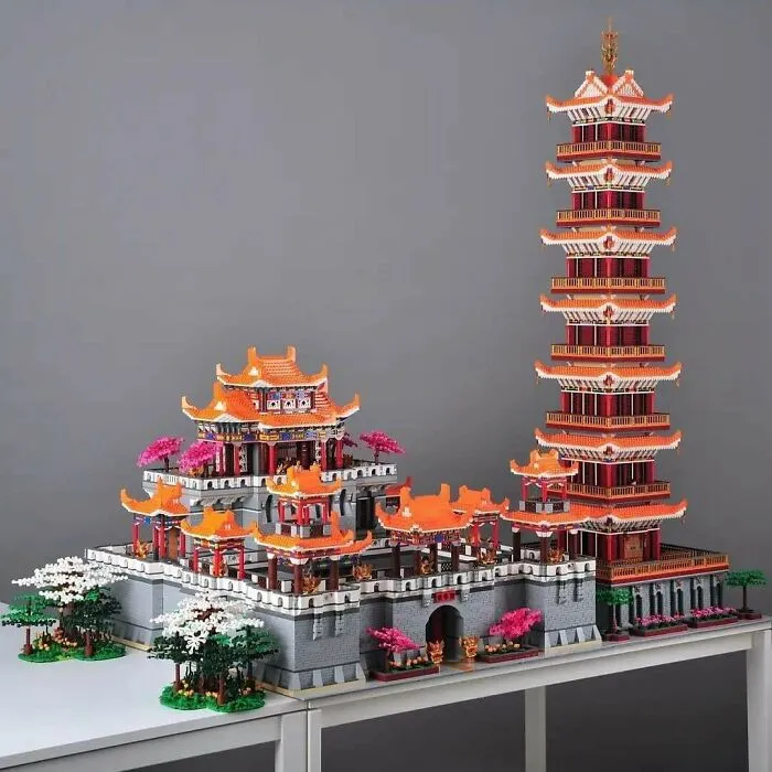 Intricate LEGO builds of traditional Asian architecture featuring pagodas and vibrant orange roofs with decorative details.