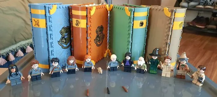 Intricate LEGO builds featuring Harry Potter mini-figures and detailed Hogwarts house-themed books as impressive works of art.