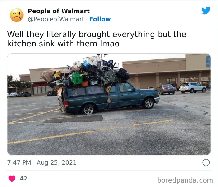 Overloaded truck in Walmart parking lot, showcasing bizarre items piled high.