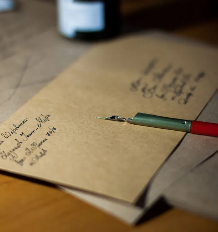 Calligraphy pen on brown paper, showcasing creative fun activities to do at home.