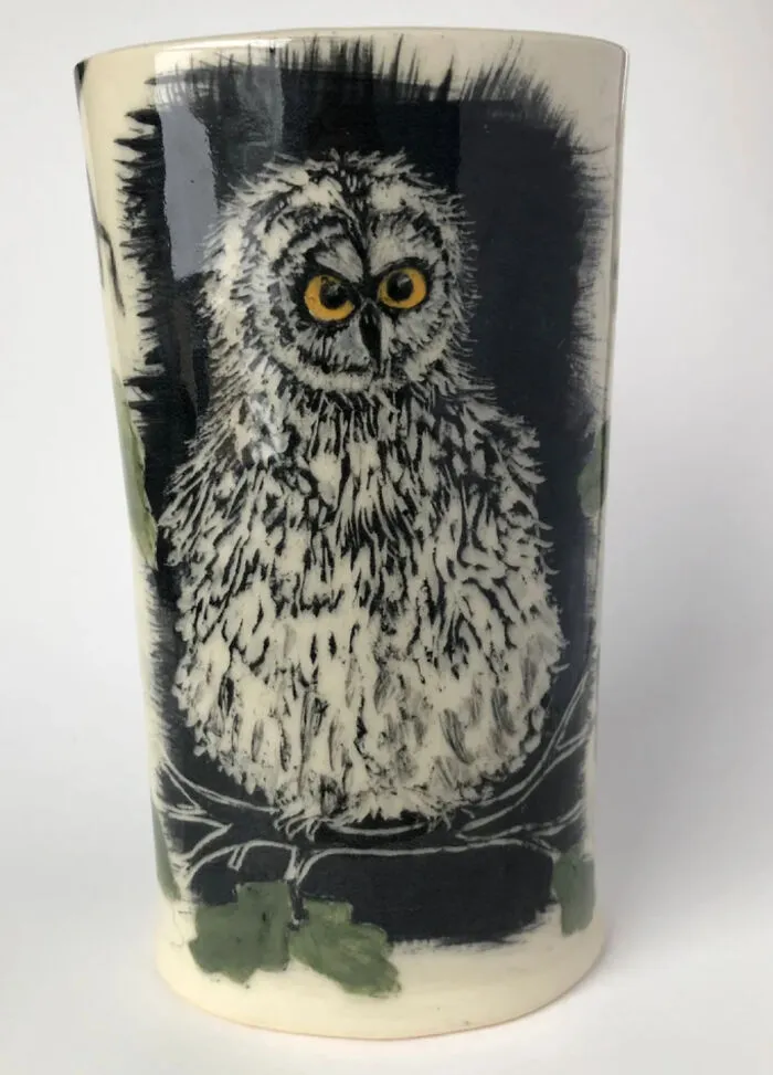A Bright-Eyed Owl Stares Hungrily, While Down Below, A Squirrel Is On High Alert